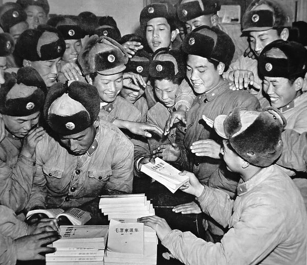 Members of the Chinese Peoples Liberation Army distributing Communist literature in