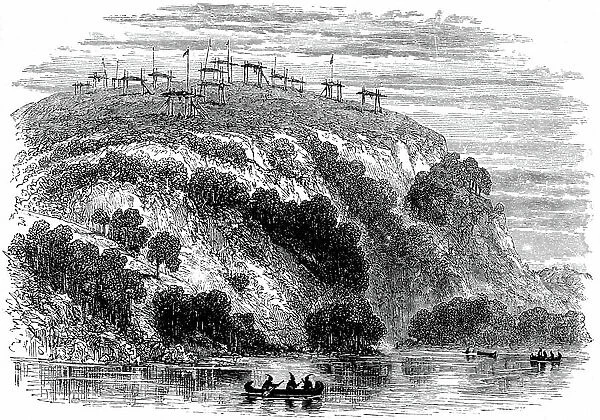 North American native burial ground, showing the dead on raised platforms. Wood engraving, 1876