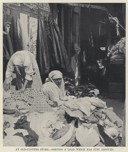 An Old-Clothes Store, sorting a Load which has just arrived (b  /  w photo)