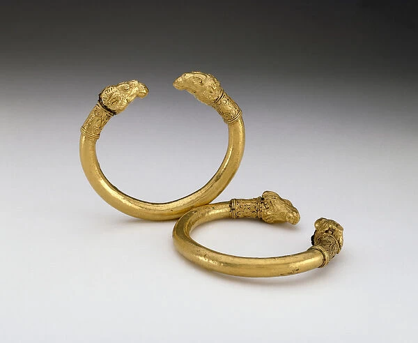 Pair of bracelets with rams head terminals (bronze and gold)