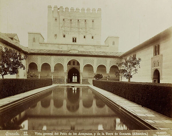 The Patio de los Arrayanes (Court of the Myrtles) and the Torre de Comares in the Palace of the Alhambra (the Red Castle) in Granada. The courtyard with the elegant porticoes on the short sides has a rectangular fishpond at the center with