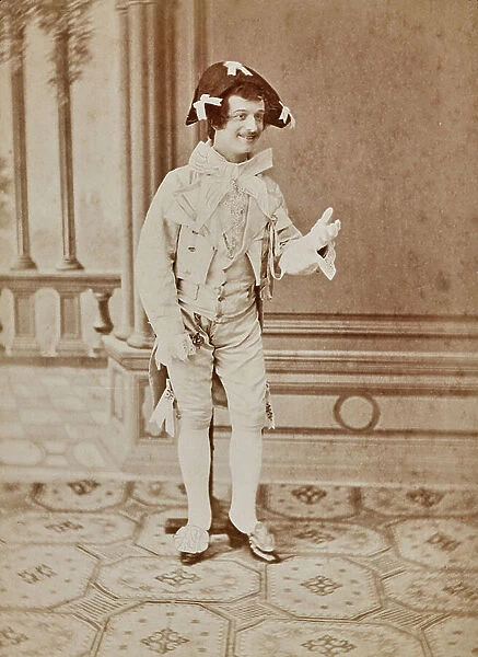 Photograph of an actor in costume for a scene in which he smiles and does a welcoming gesture