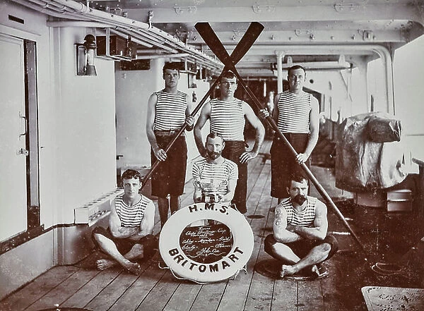 Team of oarsmen winners of the Chefoo Challenge Cup'. They are dressed in sports clothes and are posing on the main deck of a ship; the name of the team written on a life belt, stands out