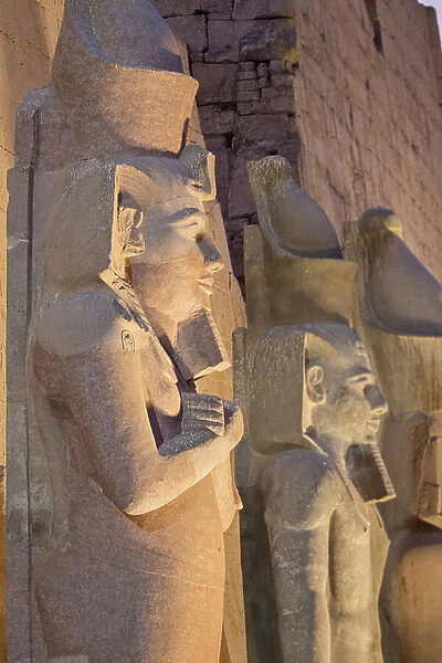 Temple of Luxor at night with colossal statues of Ramses ll, Luxor, Egypt