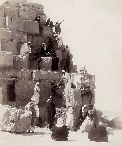 Some tourists climbing a pyramid