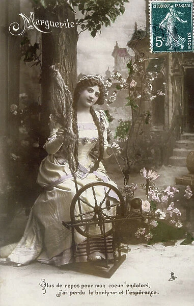 Vintage, French, postcard depicting a pensive woman in a yellow medieval costume at a spinning wheel, 1900