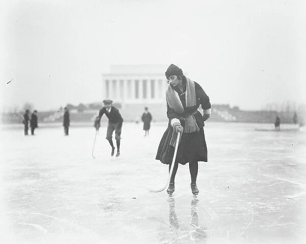 Woman Ice Skating with Hockey Stick with Lincoln Memorial in Background, Washington DC, USA, January 1922 (b / w photo)