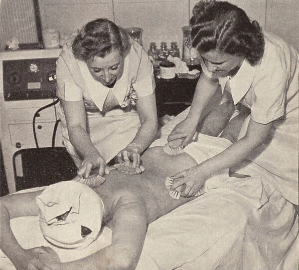 Women undergoing a body brushing beauty treatment (b  /  w photo)