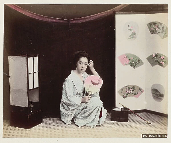 Young woman with fan and pipe near a mosquito net - Mosquito net - Japan 1880-1910 - Hand coloured photo