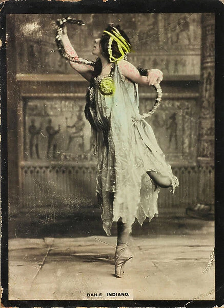 A young woman in oriental costumes performing an Indian dance
