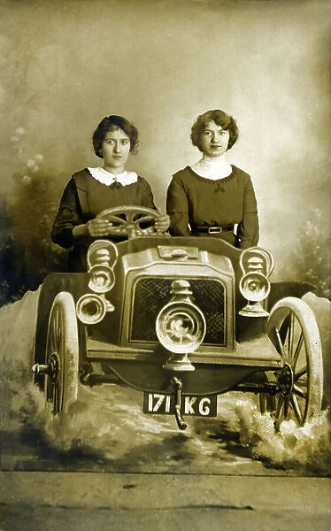Two young women driving a car, early 20th century (b / w photo)
