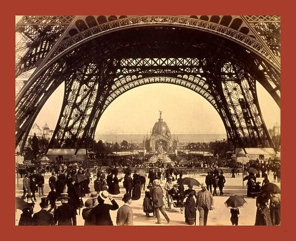 Crowd of people walking under the base of Eiffel Tower, view toward the Central Dome