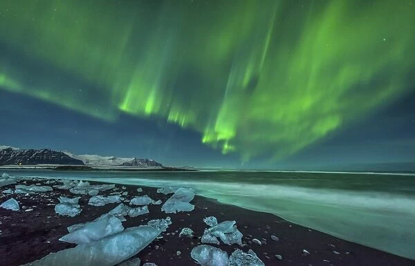 Aurora borealis over the ice beach near Jokulsarlon, Iceland