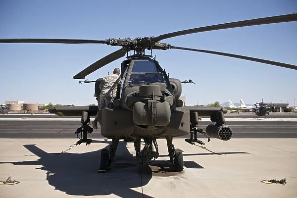 Crew chief working on an AH-64D Apache Longbow