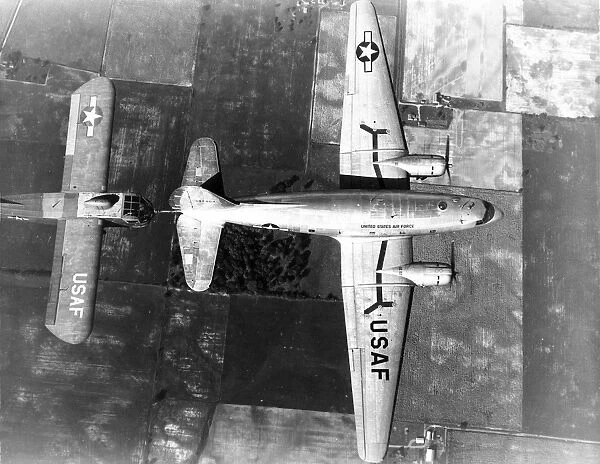 Curtiss C-46E in flight towing a Waco CG-15A glider