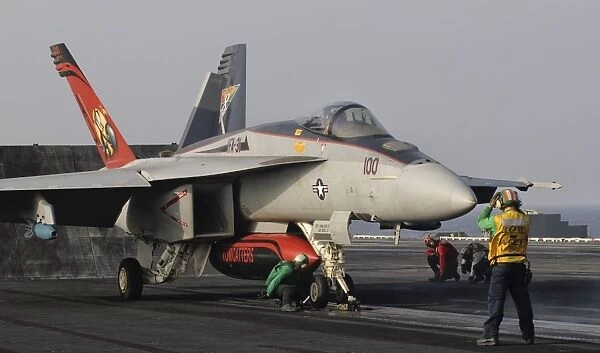 An F  /  A-18E Super Hornet moving to the catapult aboard USS George H. W. Bush