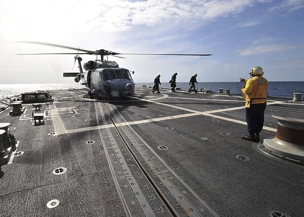 A helicpter sits on the flight deck of USS James E. Williams