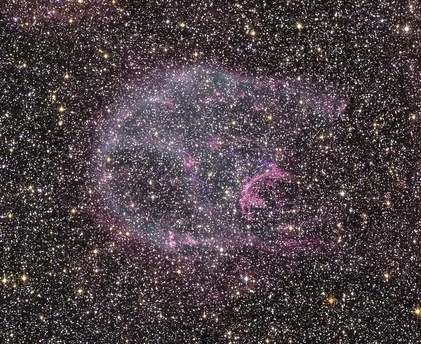 Intricate wisps of glowing gas float amid a myriad of stars