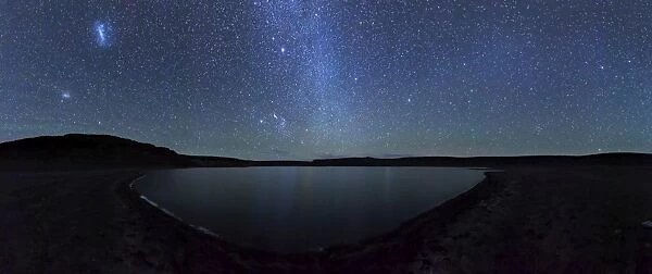 A panoramic view of the Milky Way and La Azul lagoon in Somuncura, Argentina