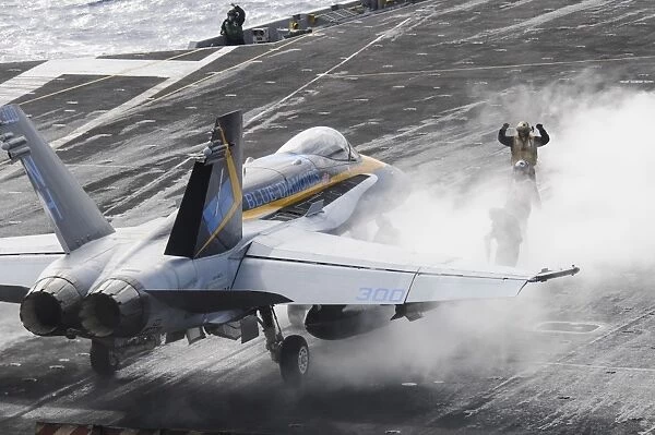 Sailors prepare an F  /  A-18C Hornet to launch from USS Nimitz