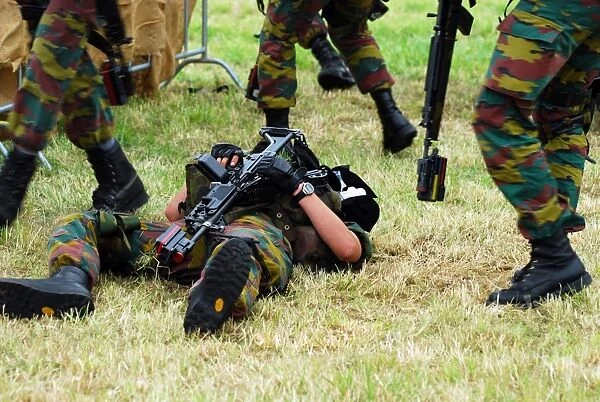 Soldiers of a Belgian Infantry unit helping out a wounded colleague on the field