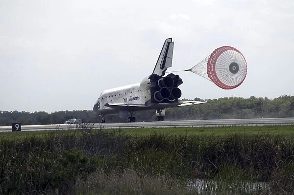 Space Shuttle Discoverys drag chute is deployed as the spacecraft rolls towards