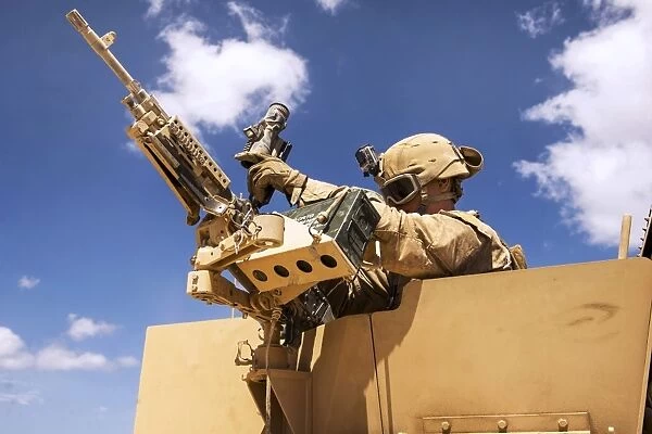 A U. S. Marine inspects his weapon