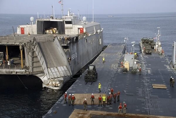 Vehicles are transferred aboard the high speed vessel Swift