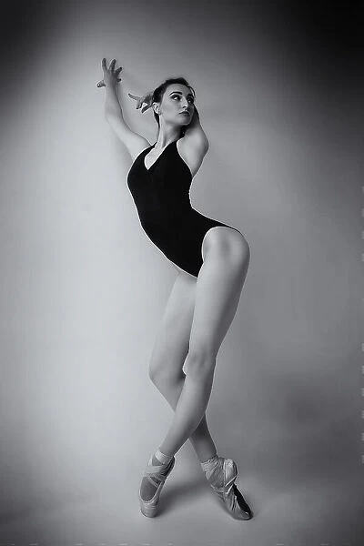 ballerina in a bodysuit improvises classical and modern choreography in a photo studio
