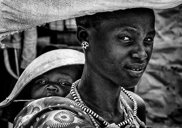 Woman with her child in a market in South Sudan