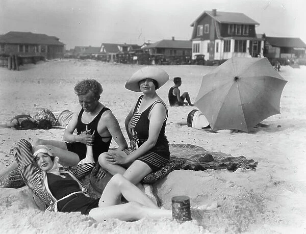 Arnold Genthe with two women friends in Long Beach, New York, between 1911 and 1942. Creator: Arnold Genthe