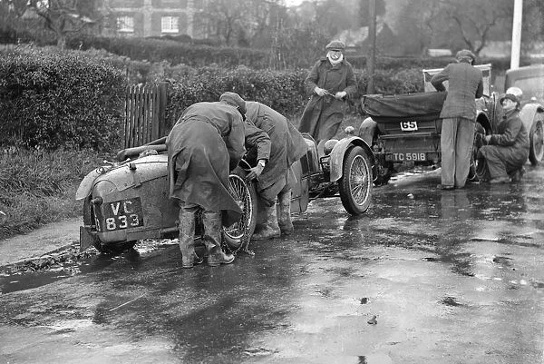 Attaching snow chains to JE Lancasters Riley Brooklands during the Inter-Varsity Trial, 1930
