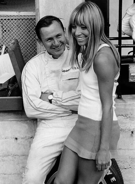 Bruce McLaren with female admirer in the pits, 1967 Italian Grand Prix. Creator: Unknown