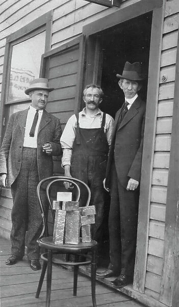 Delegate Wickersham, the assayer and Frank G. Carpenter in front of... between c1900 and 1916. Creator: Unknown