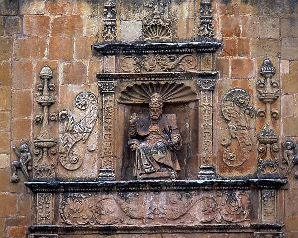 Front door of St. Peters Cathedral, crowned by the seated image of Saint Peter Pope