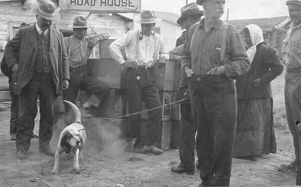 In front of Haly's Road House, Jim Haly holds a dog, between c1900 and 1916. Creator: Unknown
