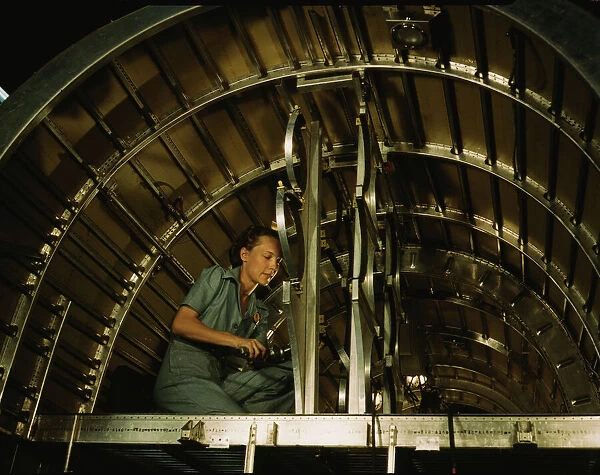 Installing oxygen flask racks above the flight... Consolidated Aircraft... Fort Worth, Texas, 1942. Creator: Howard Hollem