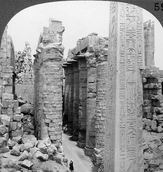 Middle aisle of the great hall and obelisk of Thutmosis I, temple at Karnak, Thebes, Egypt, 1905. Artist: Underwood & Underwood