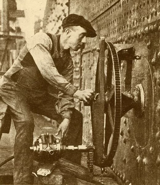 A Pneumatic Riveter Cutting Portholes in the Side of a Liner, c1930