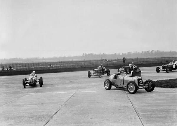 Racing cars taking a corner at Brooklands, Surrey, c1930s. Artist: Bill Brunell