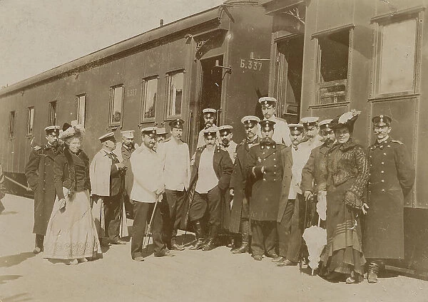 Railway employees against the background of train cars, 1910-1919. Creator: Unknown