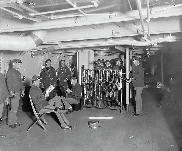 U.S.S. Brooklyn, group on gun deck, between 1896 and 1899. Creator: Unknown