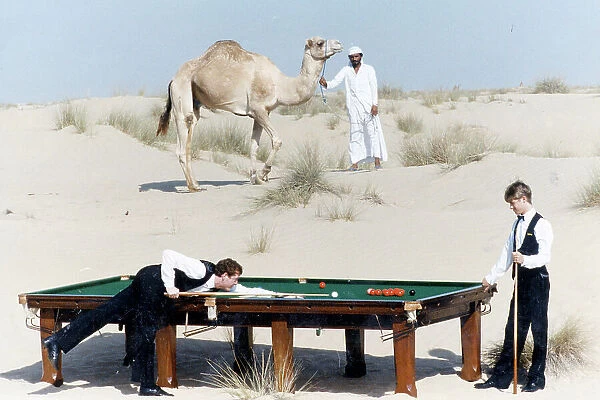 Steve Davis and Stephen Hendry Playing snooker on a table in the desert