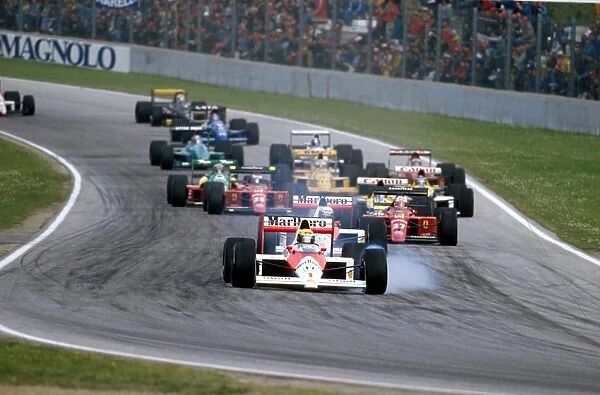 1989 San Marino Grand Prix: Ayrton Senna locks up at Tosa whilst leading the field. Ref-89 SM 07