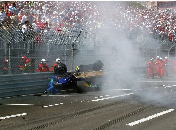 2004 Monaco Grand Prix. Monte Carlo, Monaco. 20th - 23rd May 2004. Giancarlo Fisichella climbs out from his wrecked Sauber as it lies up against the barrier. World Copyright: Adam Cooper / LAT Photographic Ref: Digital Image only