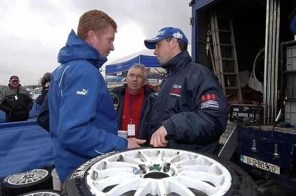 F5564. Gareth MacHale (IRL), right, discusses tyre choice with his team.