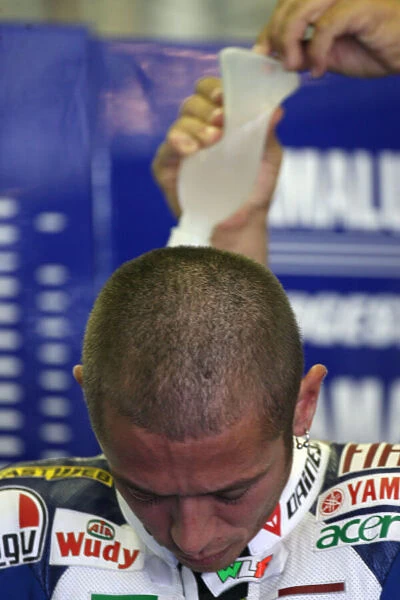 Valentino Rossi Fiat Yamaha Team gets his water drinking system refilled before Free Practice 2