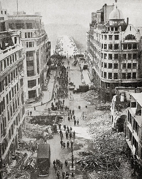 The approach to London Bridge after a German bombing attack, September 1940. Civilians making their way to work amongst the rubble. From The War in Pictures, Sixth Year.