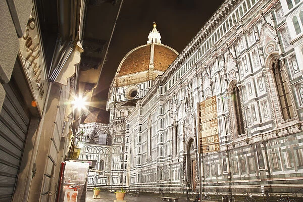 Buildings And Florence Cathedral Illuminated A Nighttime; Florence, Tuscany, Italy