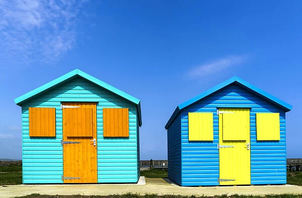 Two Colourful Buildings Side By Side With Boarded Up Windows; Amble, Northumberland, England